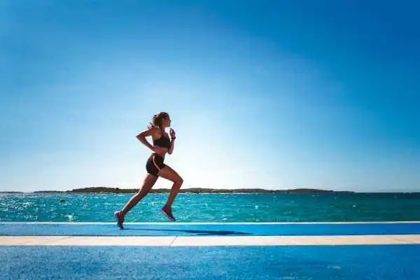 Woman running showing strong leg muscle Dudley